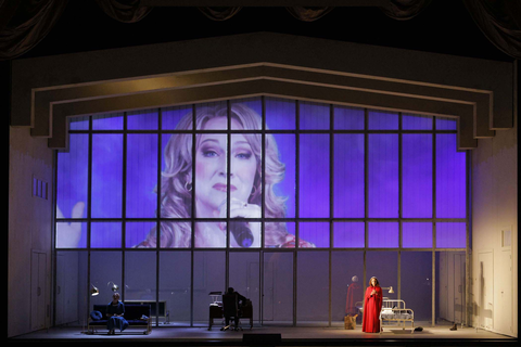 Lindsay Ammann as Serena Joy (at left and projection) and Irene Roberts as Offred in Poul Ruders and Paul Bentley's "The Handmaid's Tale." Photo: Cory Weaver/San Francisco Opera