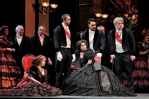 A scene from Verdi's "La Traviata" with Renée Rapier as Flora Bervoix, Anthony Reed as Doctor Grenvil, Aurelia Florian as Violetta Valéry, Amitai Pati as Gastone, and Andrew G. Manea as Marquis d'Obigny. Photographer: Cory Weaver/San Francisco Opera.