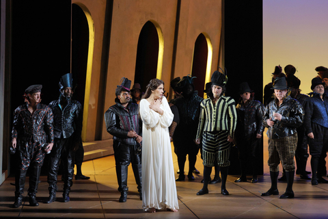 Adela Zaharia as Gilda with Olivier Zerouali as Marullo and Samuel White as Borsa with members of the San Francisco Opera Chorus in Verdi's "Rigoletto."