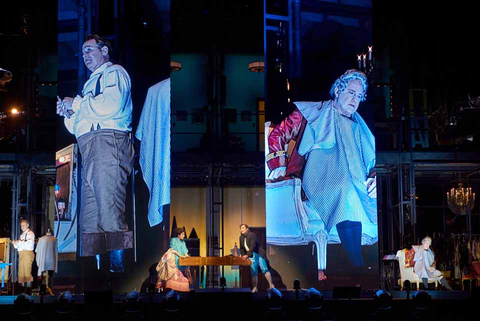 Lucas Meachem as Figaro and Philip Skinner as Dr. Bartolo projected above Meachem, Daniela Mack, Alek Shrader, and Skinner on stage level in Rossini's "The Barber of Seville." Photo: Stefan Cohen