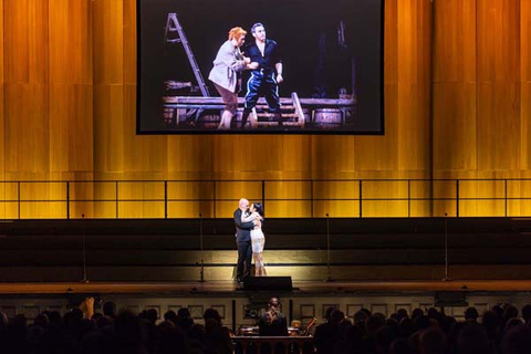 San Francisco Opera's "100th Anniversary Concert" with Michael Fabiano and Ailyn Pérez performing a duet from Giordano's "Andrea Chénier" below an archival San Francisco Opera image (Ettore Bastiani and Mario Del Monaco in Pagliacci, 1962). Photo: Drew Altizer Photography