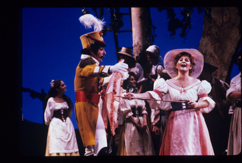 Dale Duesing (Sergeant Belcore), Alida Ferrarini (Adina), Chorus, L'Elisir d'Amore, Gaetano Donizetti. San Francisco Opera, 1984-85. Photographer: Ron Scherl/San Francisco Opera.